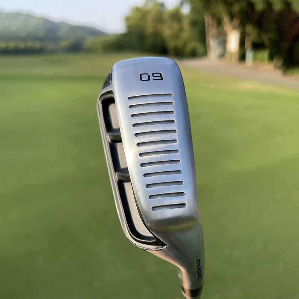 Bottom view of MAZEL 60 Degree Black Golf Chipper Club sole on golf turf – wide sole design for improved turf interaction and short game control